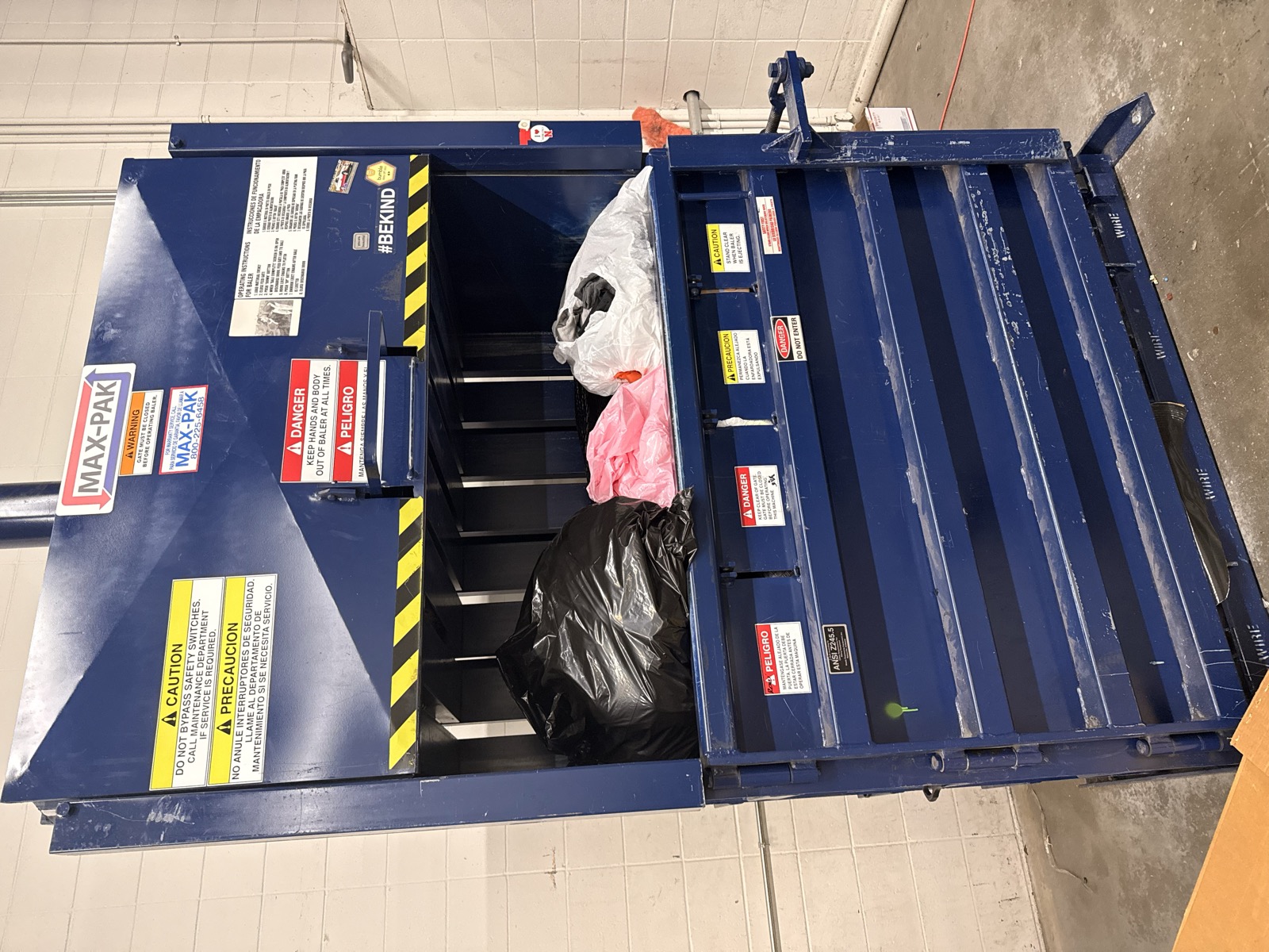 Baler machine loaded with bagged textiles at our processing facility