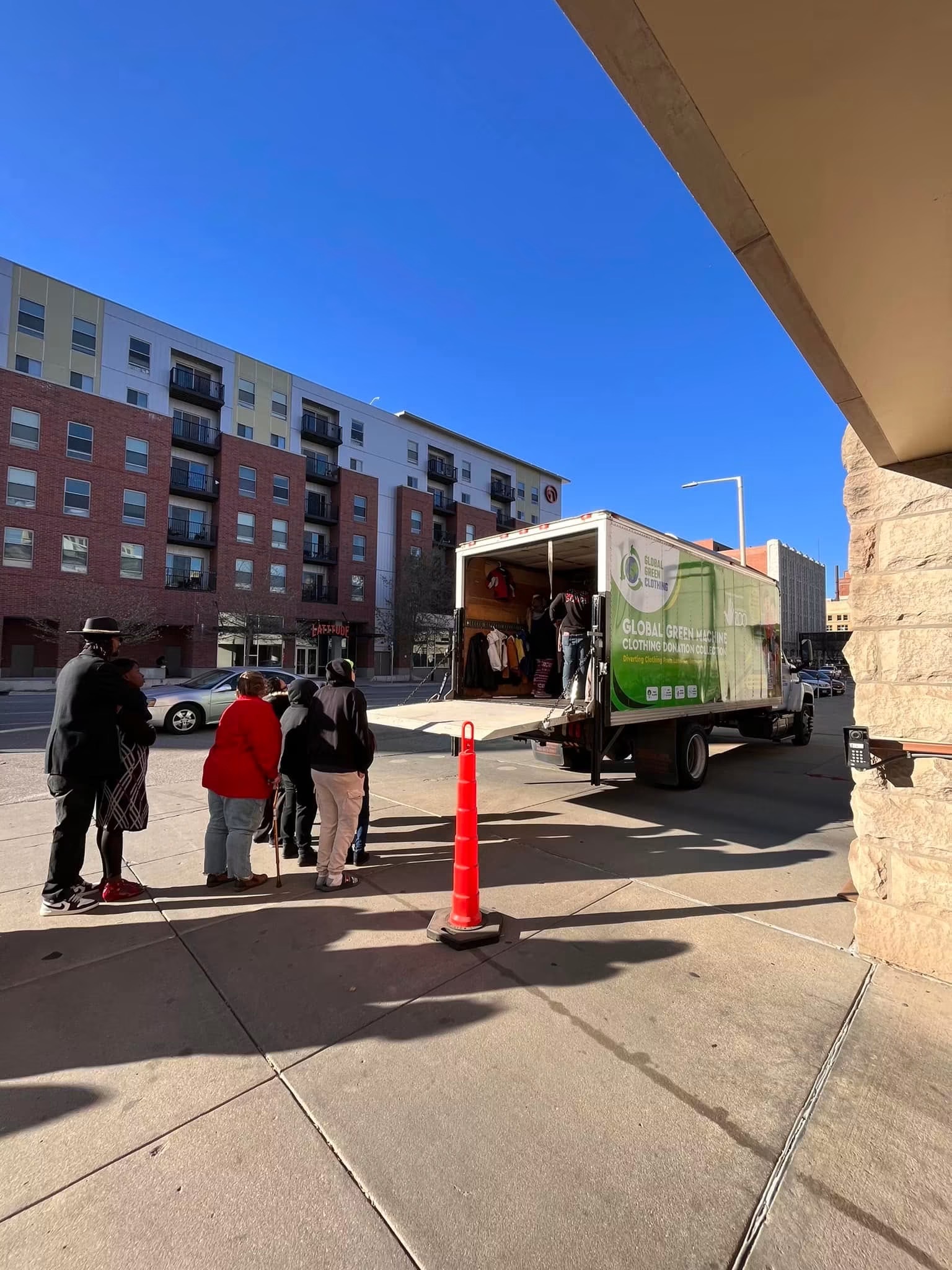 The donation truck parked in a Lincoln neighborhood with a line of people