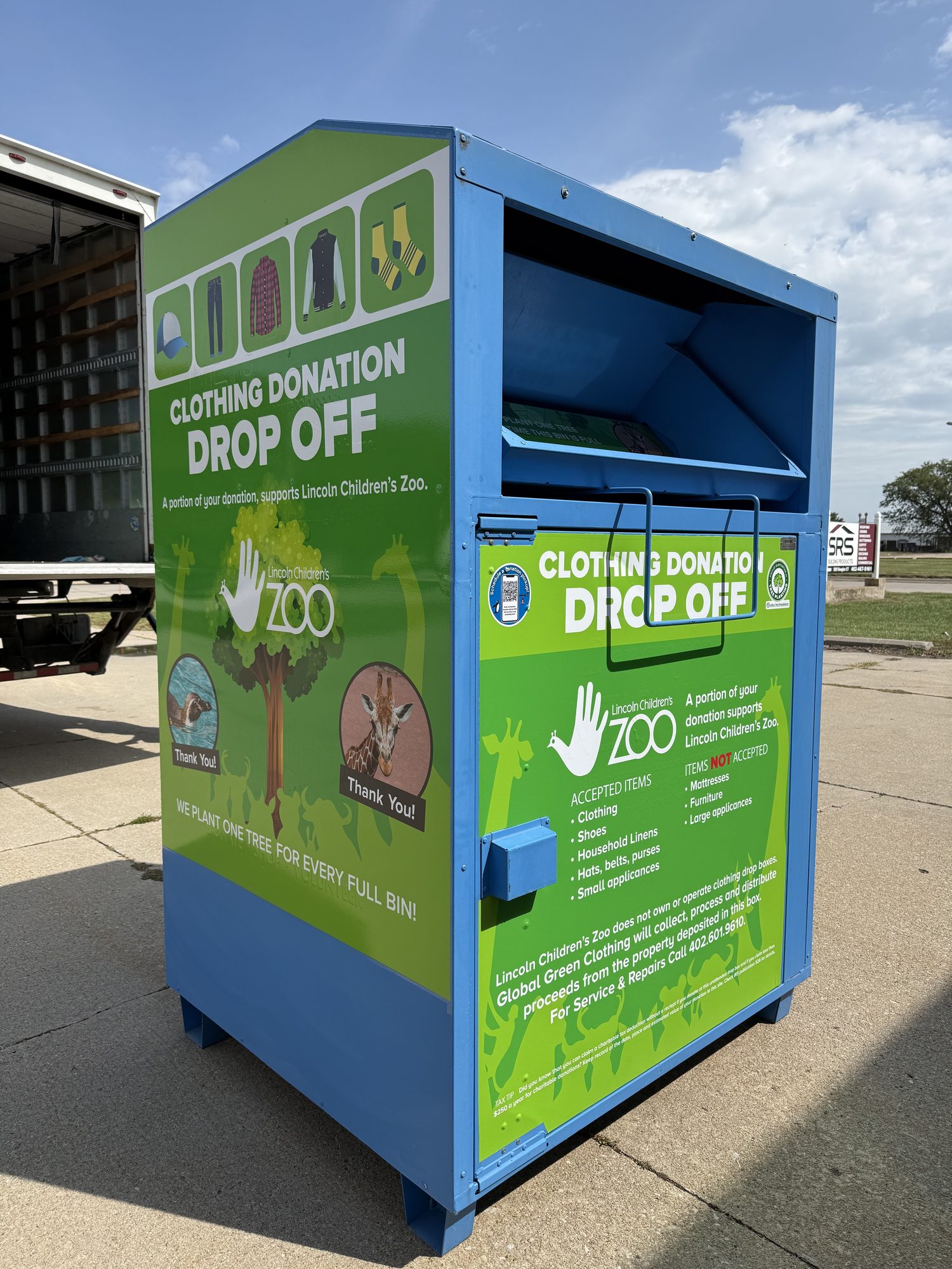 A Green Machine donation bin showing its Lincoln Children's Zoo partnership signage and tree-planting message