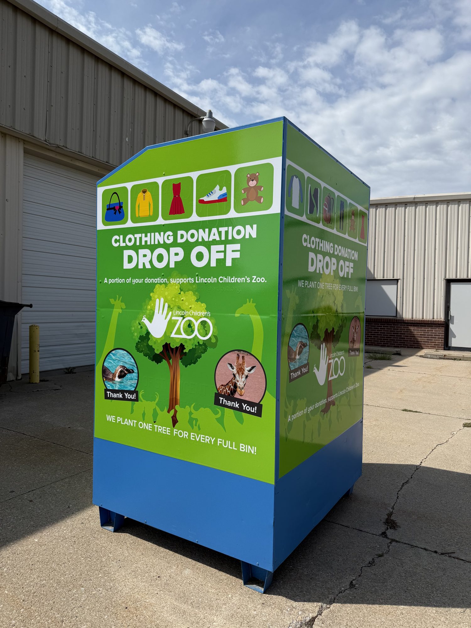 A Green Machine donation bin showing its Lincoln Children's Zoo partnership branding and tree-planting message